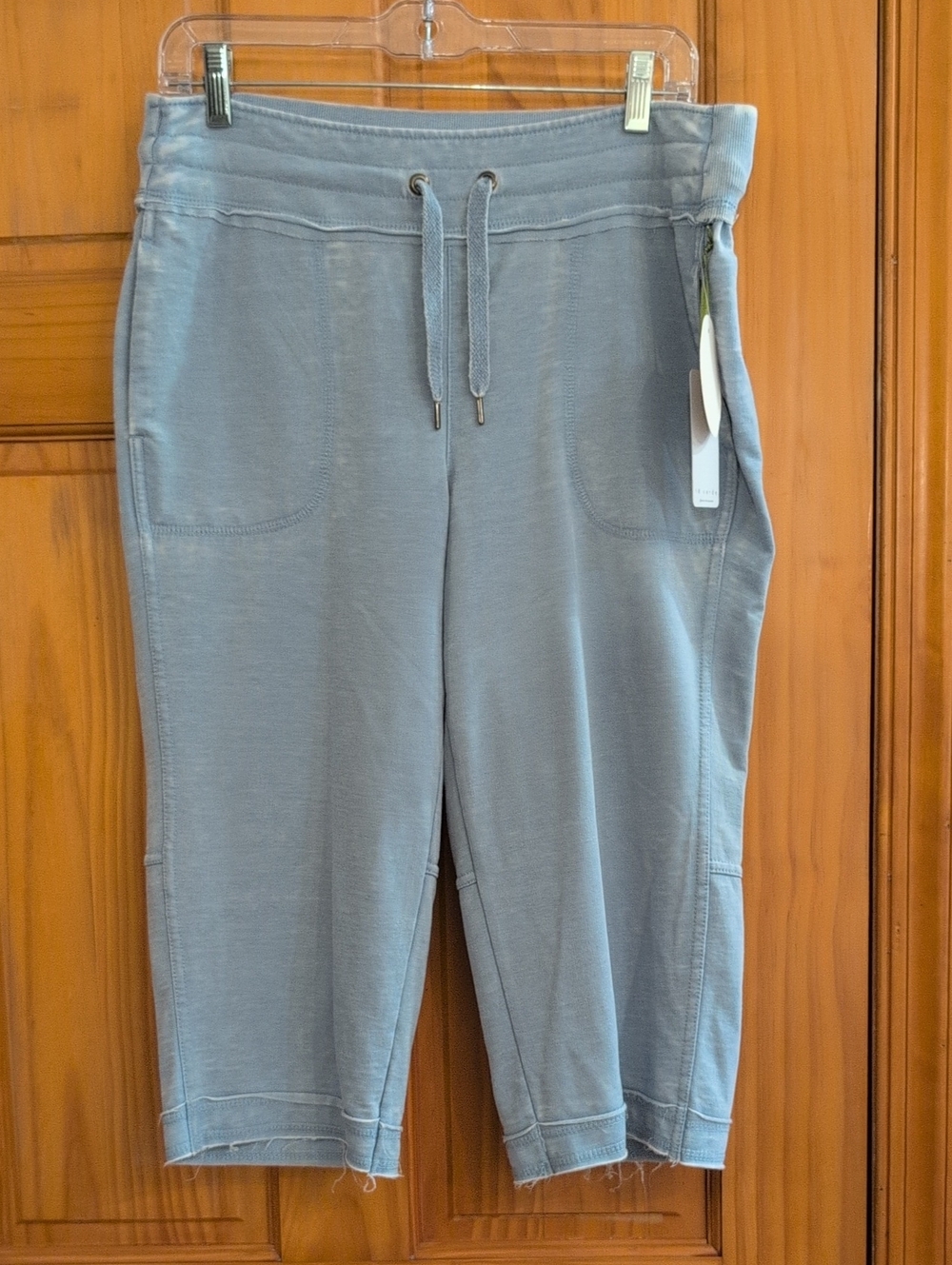 Te Verde light blue knit tag top with green hang cord